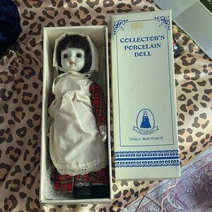 collectible porcelain doll w/ red plaid dress